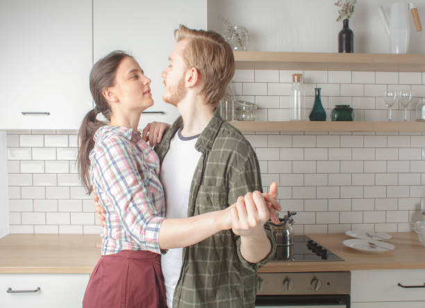 istock young couple dancing at home kitchen 908682126