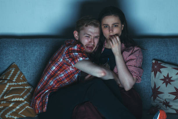 istock young couple watching horror movie 908682200