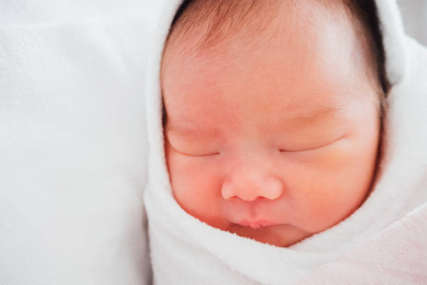 istock Newborn baby girl sleeping 908682760
