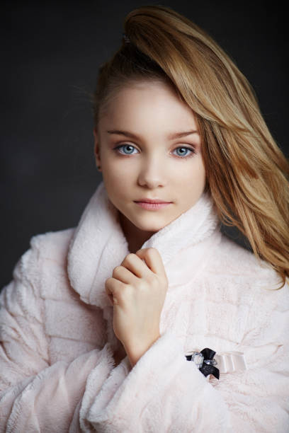 istock Modern young girl in white coat 908686136