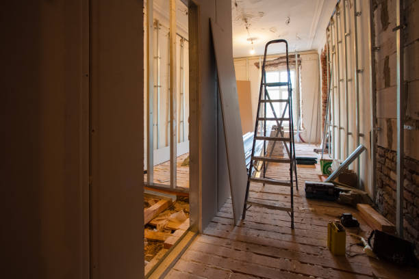 istock Interior of upgrade apartment with materials during on the remodeling, renovation, extension, restoration, reconstruction and construction. ( making wall from gypsum plasterboard). Drywall (also known as plasterboard, wallboard, gypsum board, or LAGYP) is 908689582
