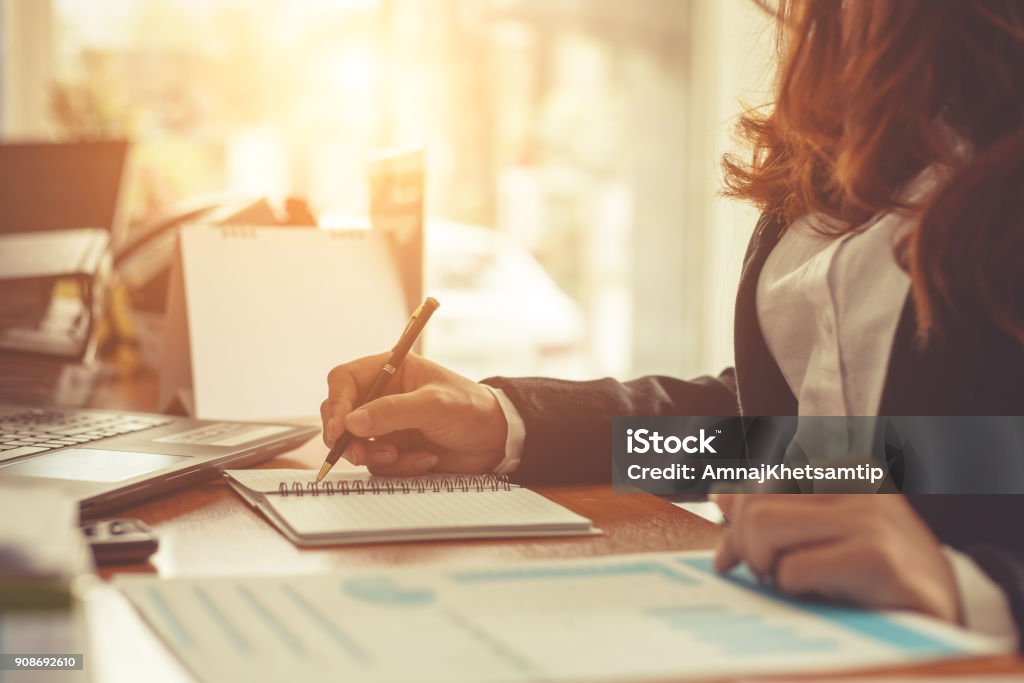 Business woman at working with financial reports and laptop computer in the office Secretary Stock Photo