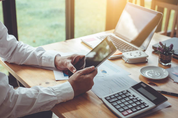 istock Business man using a working tablet in the office 908692810