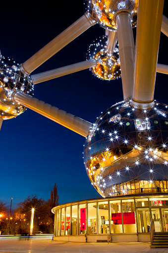 Brussels, Belgium - March 15, 2009: The Atomium is Brussel's landmark, built for the 1958 World's Fair. This iconic building forms the shape of a unit cell of an iron crystal. Detail of the illuminated Atomium with the entrance.