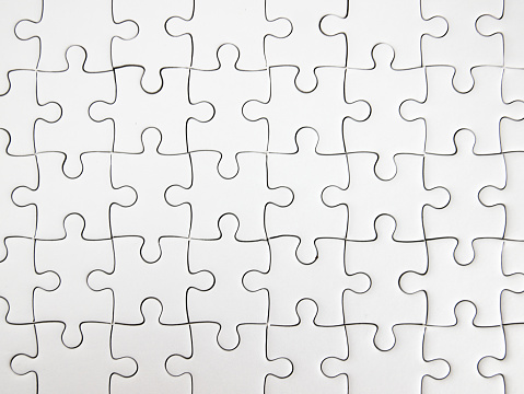 White jigsaw puzzle pieces completed as copy space.