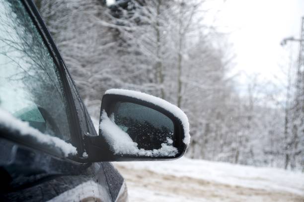 istock Rear car mirror with snow during winter. 908700170