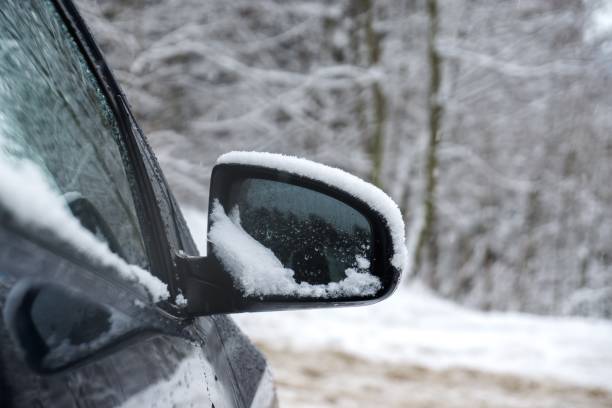 istock Rear car mirror with snow during winter. 908700192