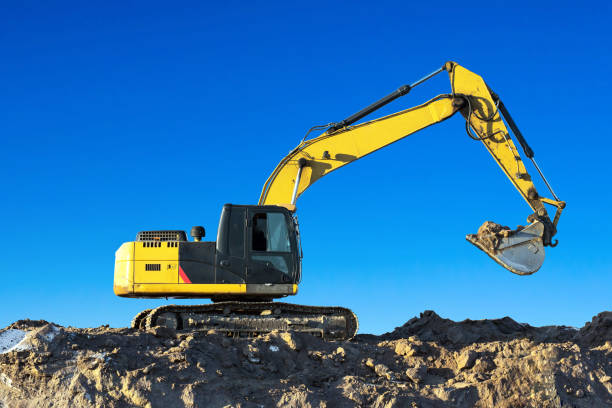 istock Excavator work on the ground on background blue sky. 908700254