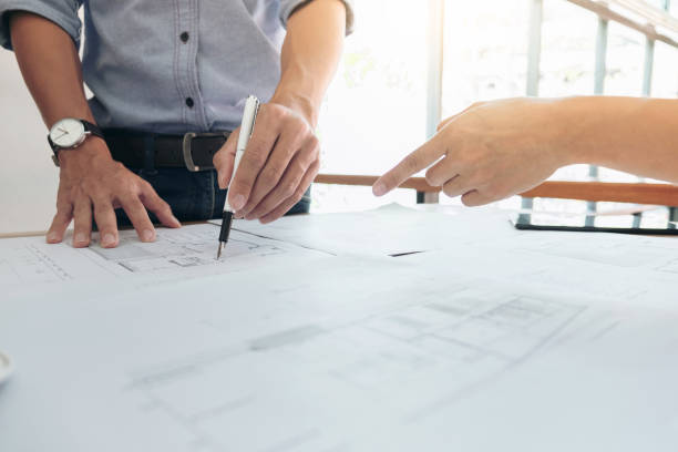 istock Image of engineer or architectural project, Close up of hands architects engineering working on blueprint with engineering equipment tool, Construction concept 908704484