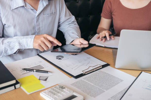 istock Young businessteam working with new startup project. discussing the charts and graphs showing the results at meeting. Business accounting and financial concept 908704580