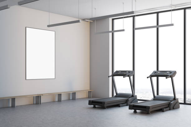 istock Two treadmills in a white room, side view 908707874