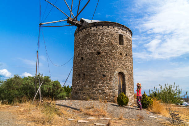 istock A woman tourist is visiting an old windmill. 908708416