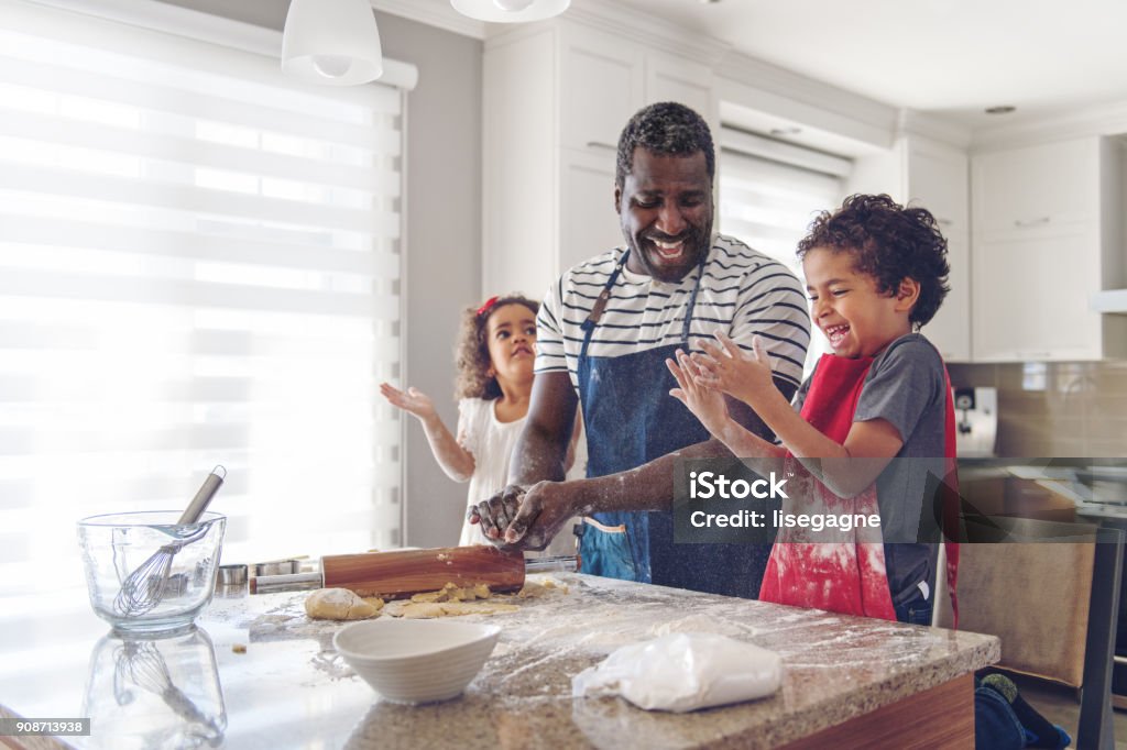 Father cooking with kids Muti-ethnic family cooking Family Stock Photo