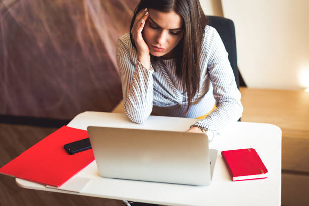 istock Young woman working at the laptop at the office 908714450