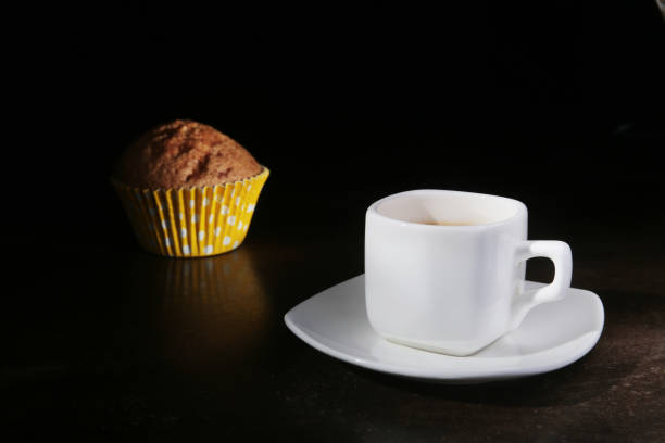 Homemade muffin with raisins and cup classic espresso coffee. selective focus.