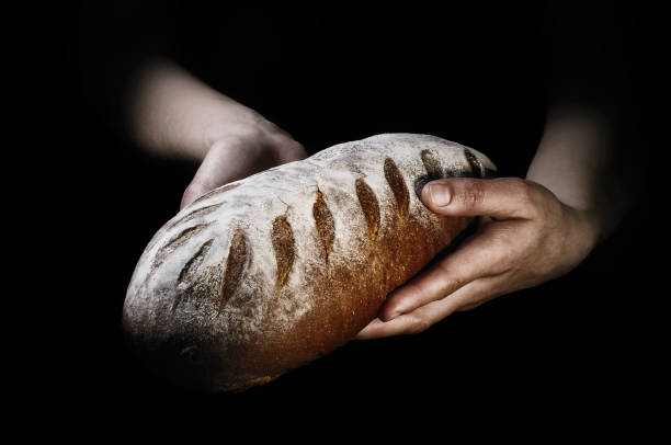 istock Freshly baked bread on a black background. 908720602