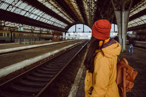 istock woman wiating for train on railway station 908730428
