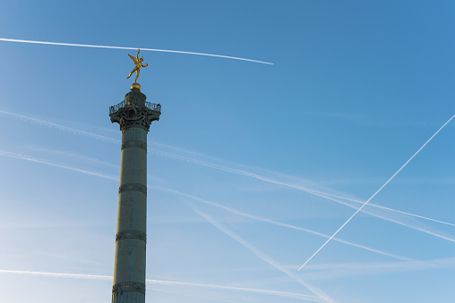 Bastille column with chemtrails on a blue sky in Paris - France