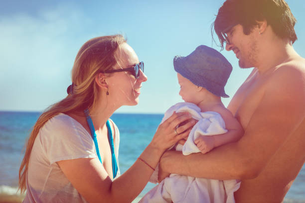 istock Family playing on the beach 908731340