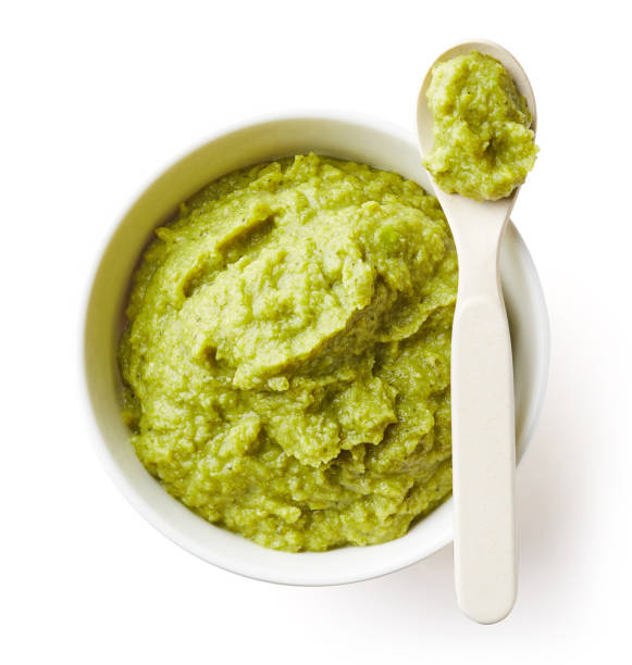 Green peas and broccoli baby puree isolated on white
