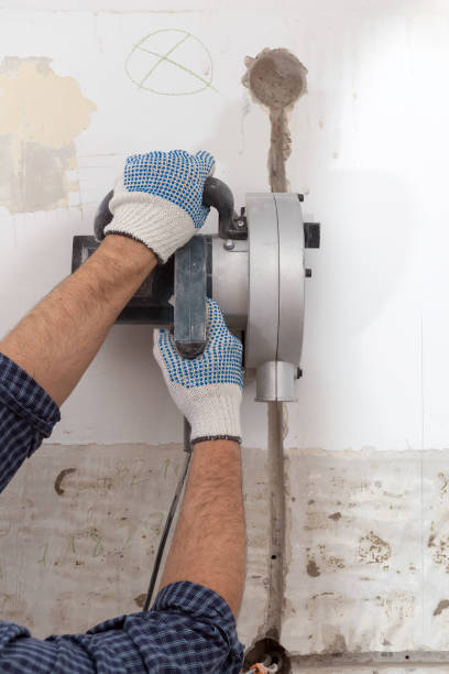 istock Cutting electrical chase in the concrete wall with groove cutter 908734592