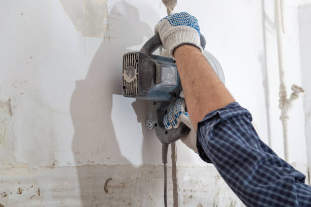 istock Cutting electrical chase in the concrete wall with groove cutter 908734658