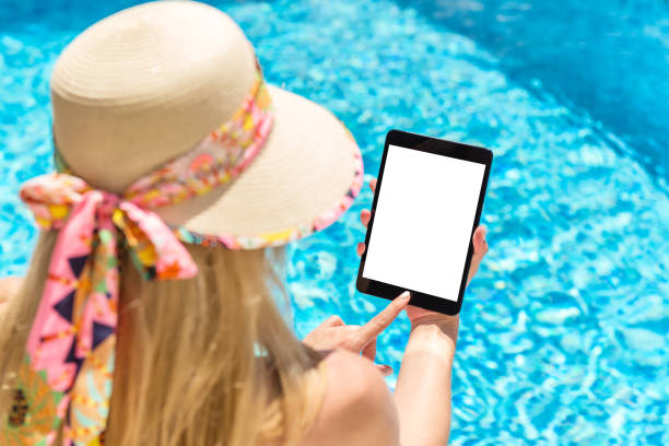 istock Freelance work & woman by the pool 908736950