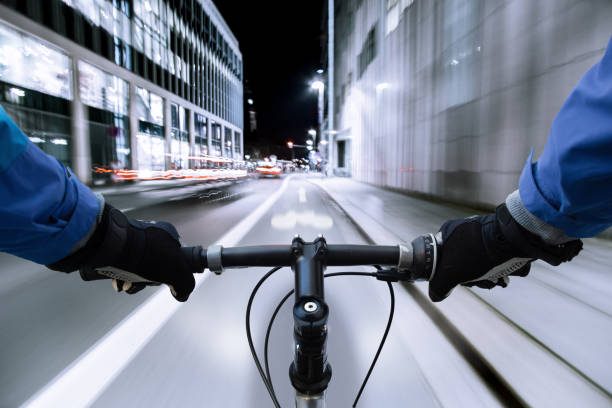 istock Cyclist on the bike path at night - First-person view 908737374