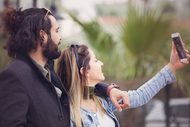 istock Happy young couple taking selfie 908741416