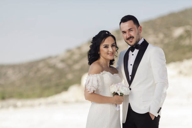 istock Bride and groom smiling for the camera 908741492