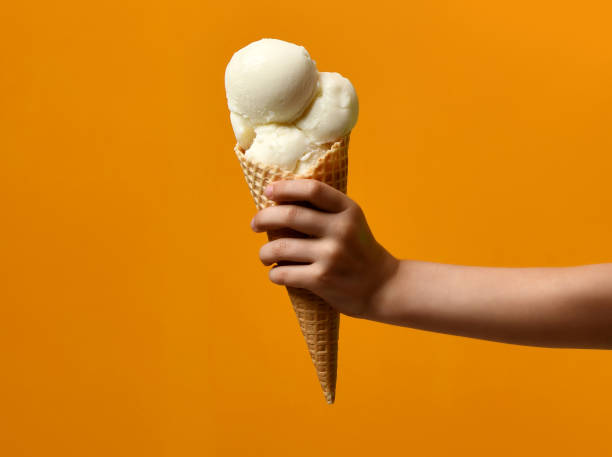 istock Fresh white ice cream waffles cone in kid hand 908742466