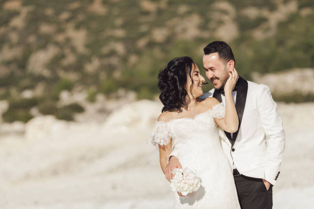 istock Bride and groom gazing eachother 908744662
