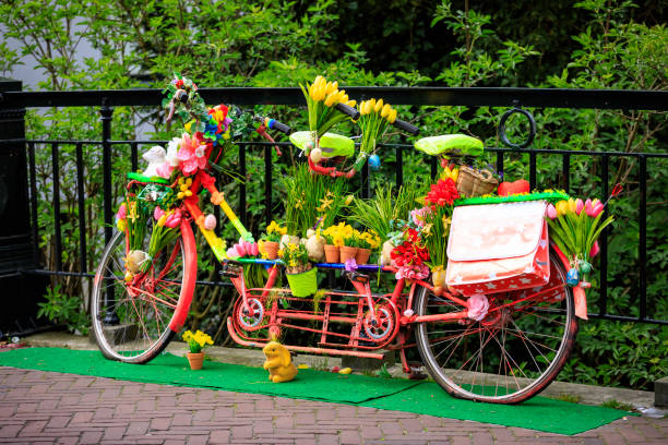 an old Easter decorated tandem bicycle parked on the bridge in the street of Edam city center