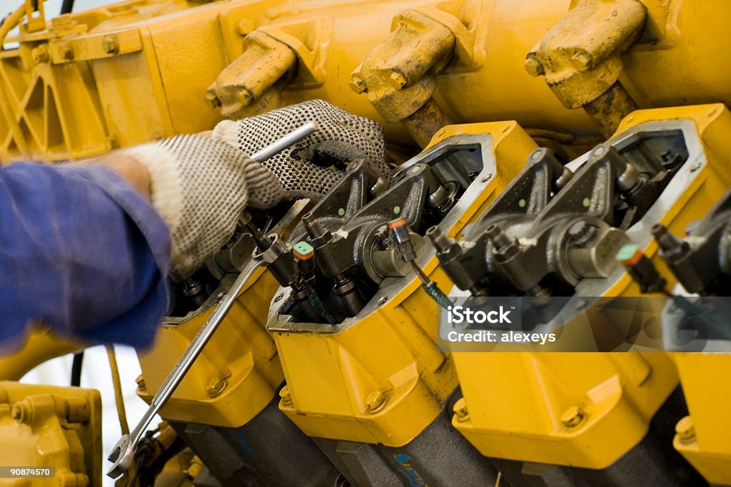 Large engine maintenance being performed A technician performing periodic engine maintenance in a landfill gas recovery plant Repairing Stock Photo