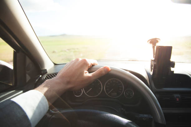 istock young man in suit driving car 908748646