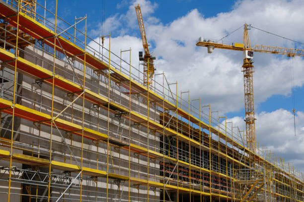 istock new building construction site,  scaffolding and crane on bulding site 908749250