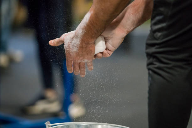 istock Close up selective focus of male hands preparing with chalk magnesium before exercise. 908752606