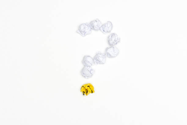 istock Question mark sign with crumpled paper balls on white background 908753026