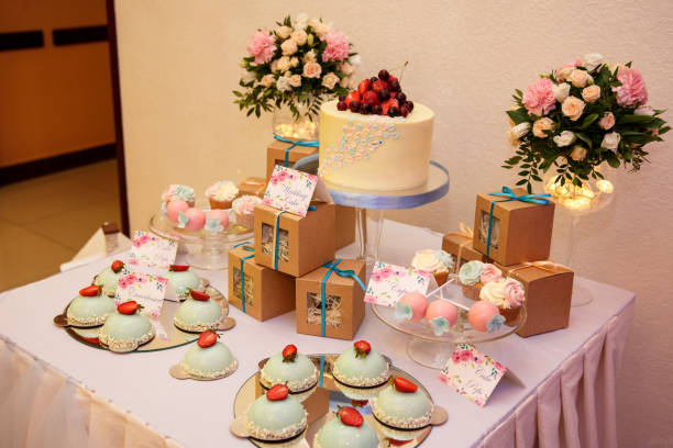 istock Wedding cake and other sweets on candy bar. Catering service at wedding day 908755566