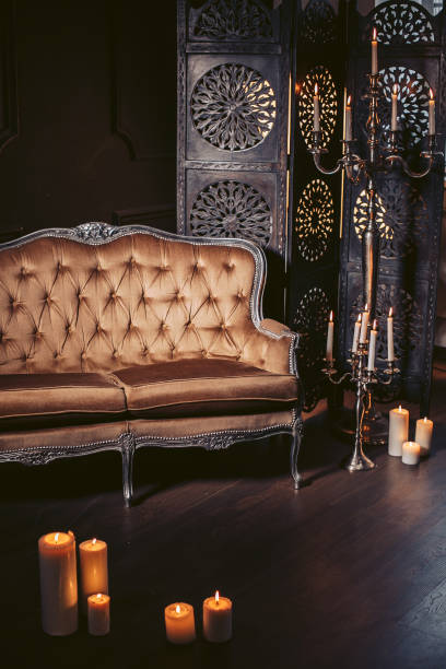 istock Luxurious sofa in a modern interior, decorated with decor and candles 908758910