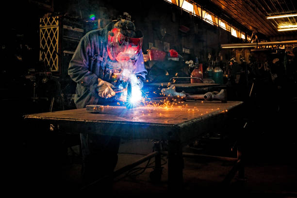 Blue collar Industrial worker welding stock photo