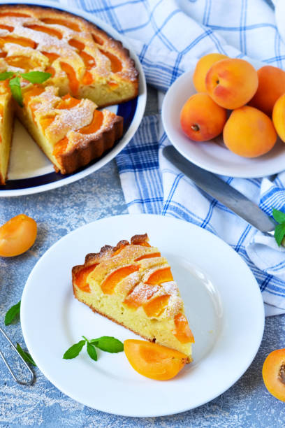 istock Homemade cake with apricots and nectarines on a concrete background. 908759360