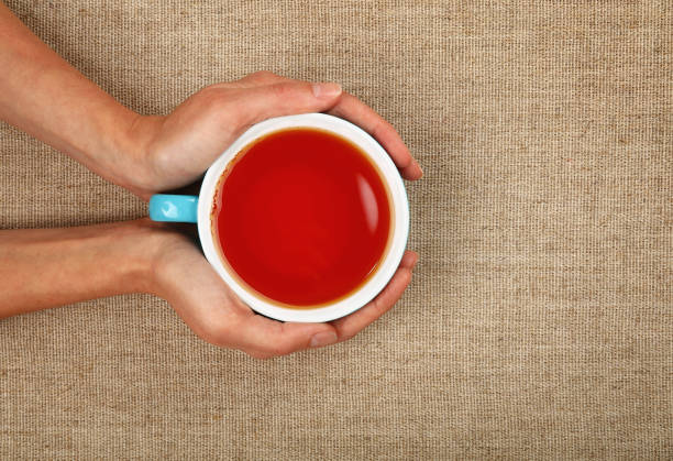 istock Cropped Image Of Hands Holding Tea Cup 908762080