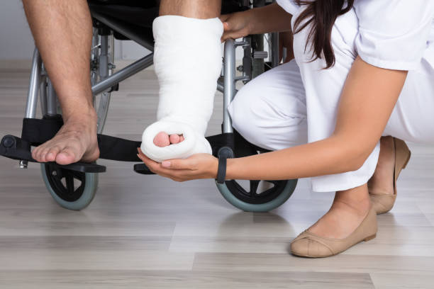 istock Doctor Holding Disabled Patient's Leg 908764916