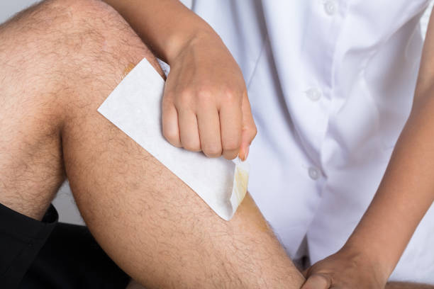istock Beautician Waxing Man's Leg 908765026