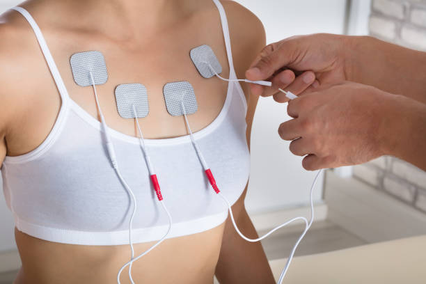 istock Therapist Giving Electrodes Therapy To Woman 908765078