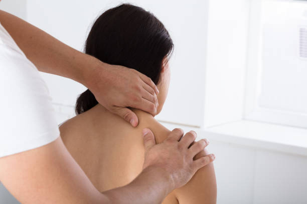 istock Young Woman Receiving Shoulder Massage 908765120