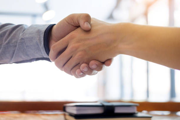 istock Cropped Hands Of People Giving Handshake At Office 908770824
