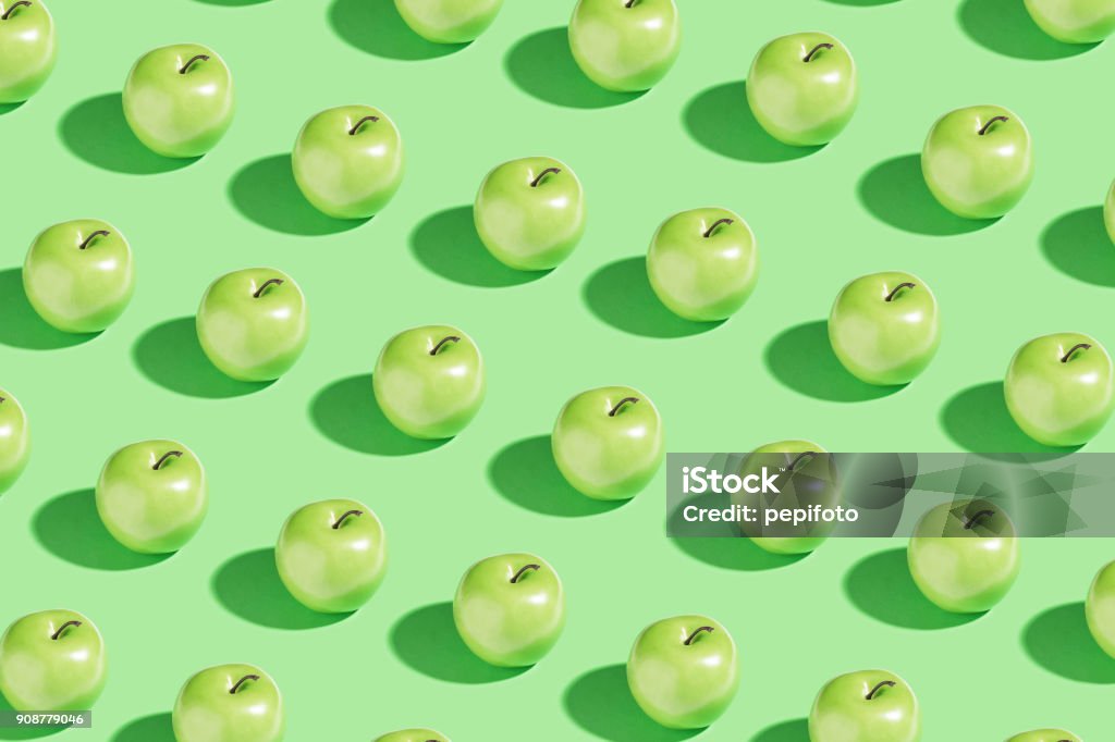 Green apple Green apple on green background Apple - Fruit Stock Photo