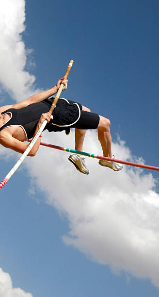 istock Athlete pole vaulting on a sunny day against sky background 90878575